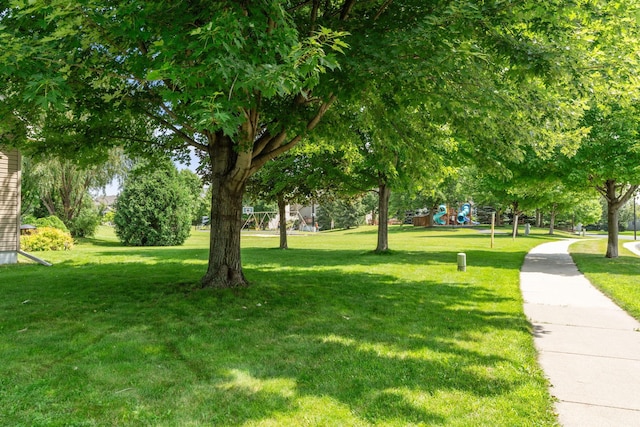 view of community with playground community and a yard