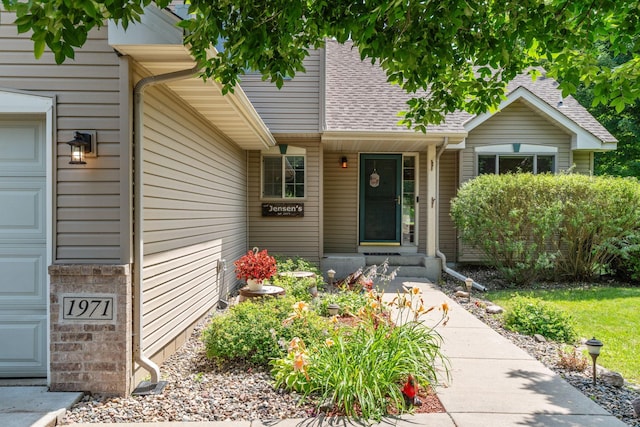 property entrance featuring roof with shingles