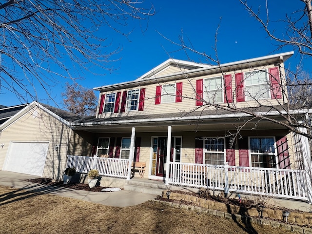 view of front of home with a porch, an attached garage, and driveway