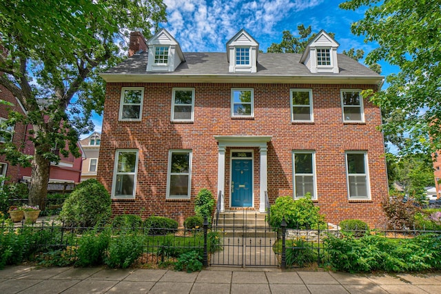 355 Laurel Ave, Saint Paul, MN 55102 - view of front of house with a fenced front yard, brick siding, a gate, and a chimney
