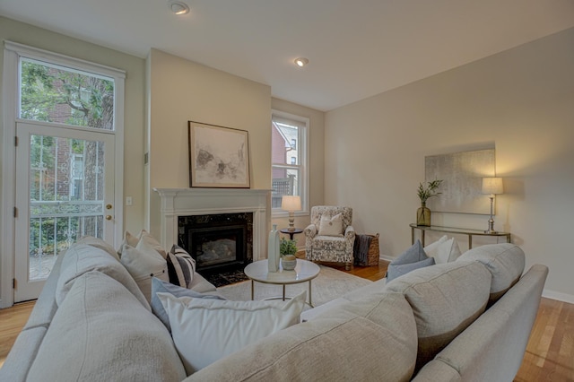 355 Laurel Ave, Saint Paul, MN 55102 - living room featuring light wood finished floors, a premium fireplace, and recessed lighting