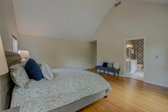 355 Laurel Ave, Saint Paul, MN 55102 - bedroom featuring light wood-style floors, high vaulted ceiling, and connected bathroom