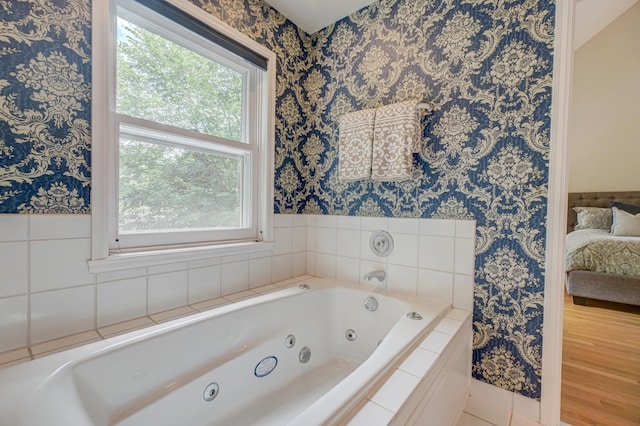 355 Laurel Ave, Saint Paul, MN 55102 - ensuite bathroom with wallpapered walls, a whirlpool tub, and healthy amount of natural light