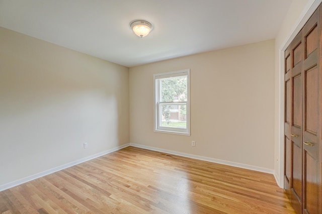 355 Laurel Ave, Saint Paul, MN 55102 - unfurnished bedroom with light wood-style floors and a closet