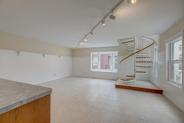 355 Laurel Ave, Saint Paul, MN 55102 - spare room featuring track lighting, stairs, and light tile patterned flooring
