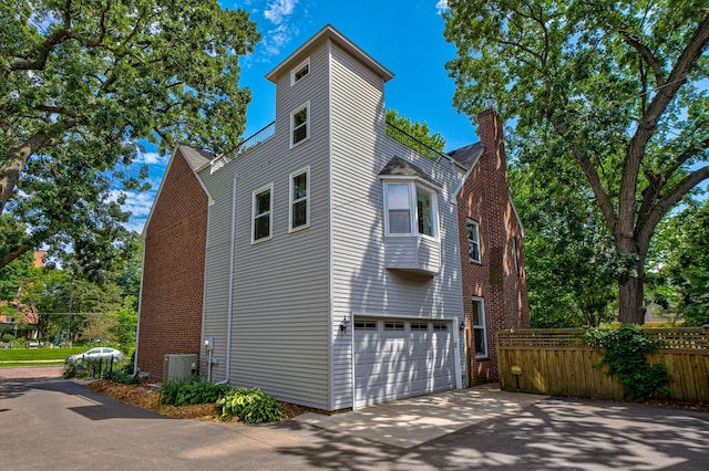 355 Laurel Ave, Saint Paul, MN 55102 - view of side of home featuring a garage, a chimney, and driveway