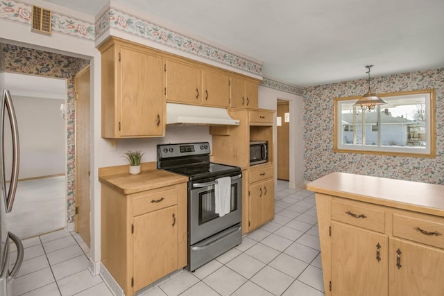 kitchen with under cabinet range hood, stainless steel appliances, light countertops, and wallpapered walls