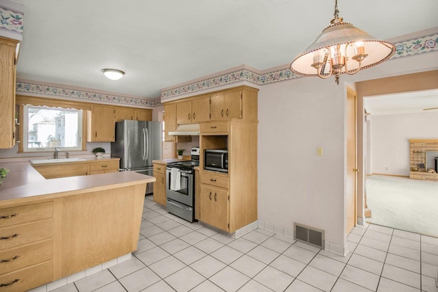 kitchen with visible vents, under cabinet range hood, light countertops, appliances with stainless steel finishes, and light tile patterned flooring