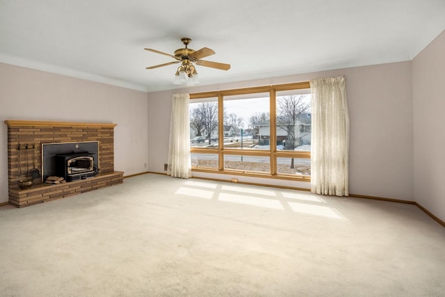 unfurnished living room with carpet, baseboards, and ceiling fan