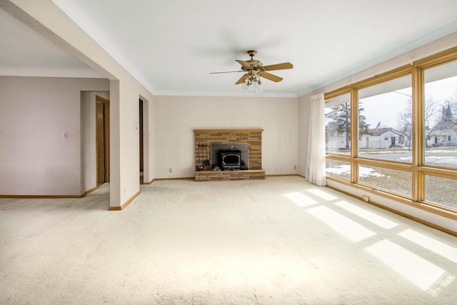 unfurnished living room with light carpet, a ceiling fan, and baseboards