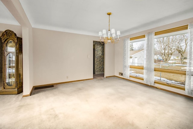 unfurnished dining area with baseboards, carpet floors, and a chandelier