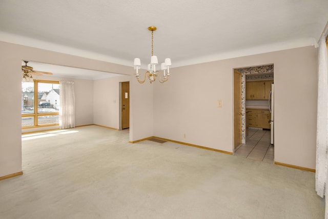 empty room with light carpet, ceiling fan with notable chandelier, and baseboards