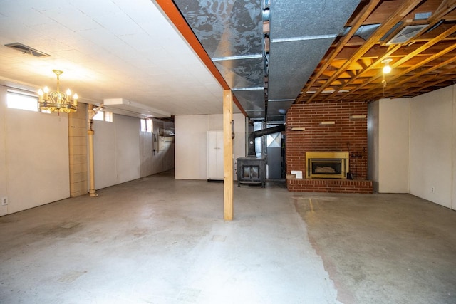 below grade area featuring a wood stove and visible vents