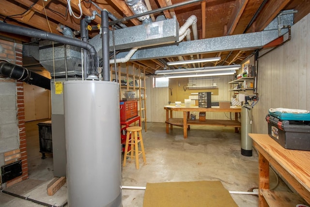 below grade area with a workshop area and water heater