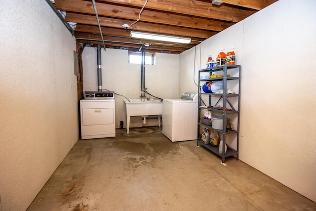 below grade area featuring washer and dryer and a sink