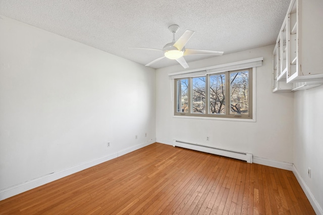 unfurnished room with a ceiling fan, baseboards, a textured ceiling, light wood-type flooring, and baseboard heating