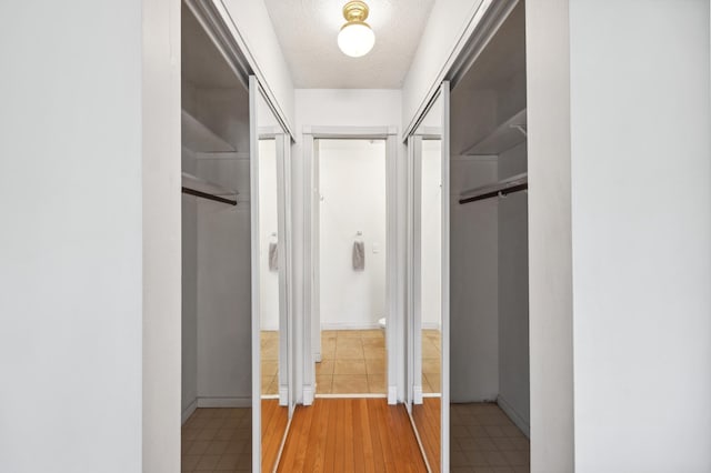 hallway with a textured ceiling