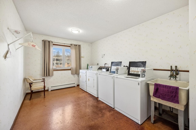 common laundry area featuring a baseboard heating unit, washing machine and clothes dryer, and wallpapered walls