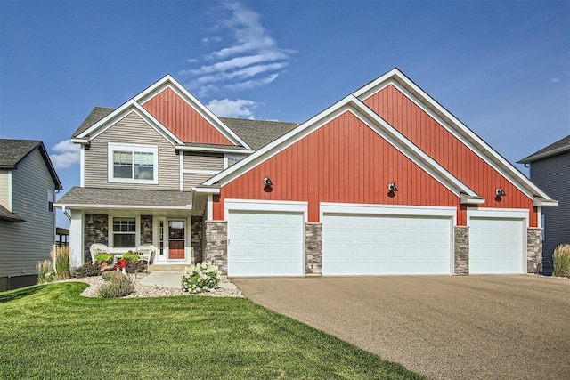 craftsman inspired home featuring stone siding, driveway, and a front lawn