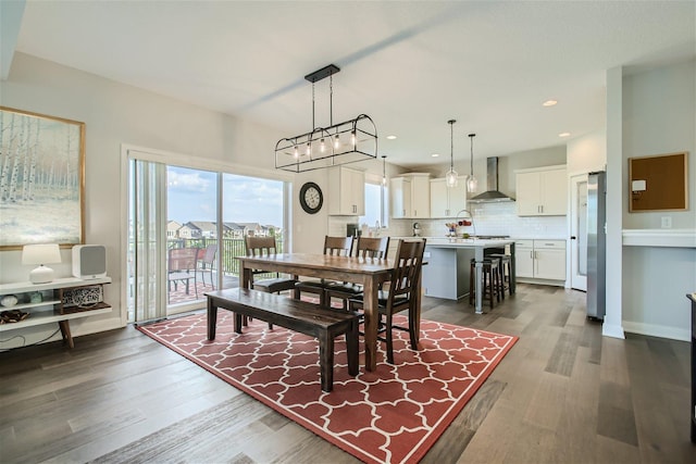 dining room featuring dark wood-type flooring, recessed lighting, and baseboards