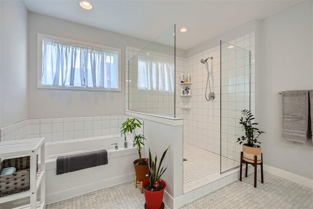 full bath featuring recessed lighting, baseboards, a bath, and a walk in shower