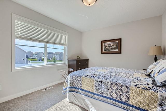 bedroom with carpet flooring, visible vents, and baseboards