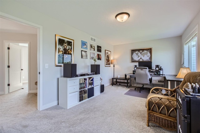 office featuring carpet floors, visible vents, and baseboards