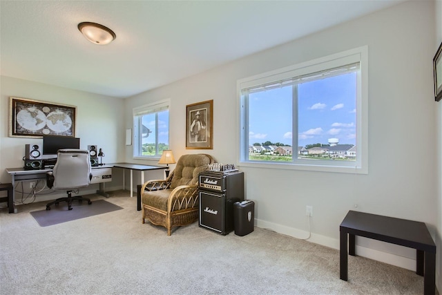 carpeted office featuring baseboards