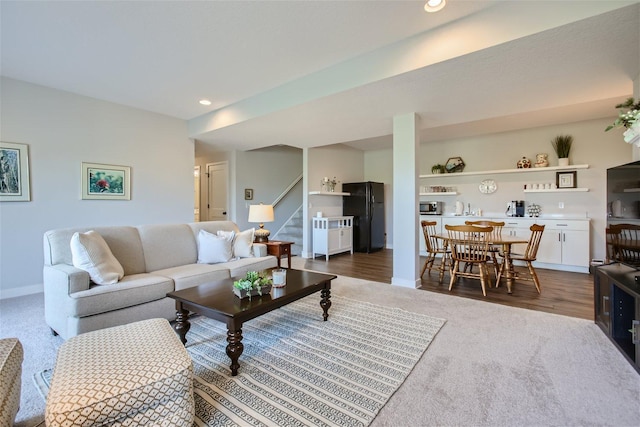 living area with stairs, baseboards, dark wood-type flooring, and recessed lighting