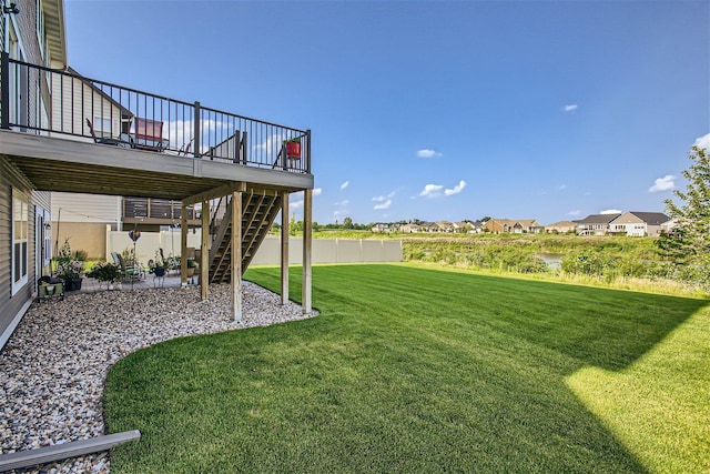 view of yard featuring a patio, a wooden deck, and stairs