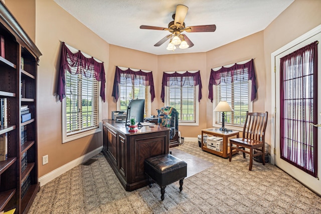 office space with ceiling fan, a wealth of natural light, and baseboards