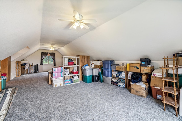 interior space with vaulted ceiling, carpet flooring, and a ceiling fan