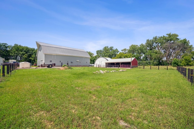 view of yard with an outbuilding and fence