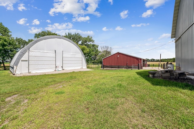 view of yard with an outbuilding, an outdoor structure, and fence