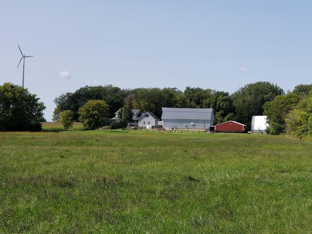 view of yard with an outbuilding, a rural view, and a garage