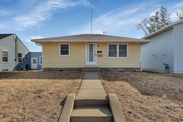 bungalow-style home with a shingled roof