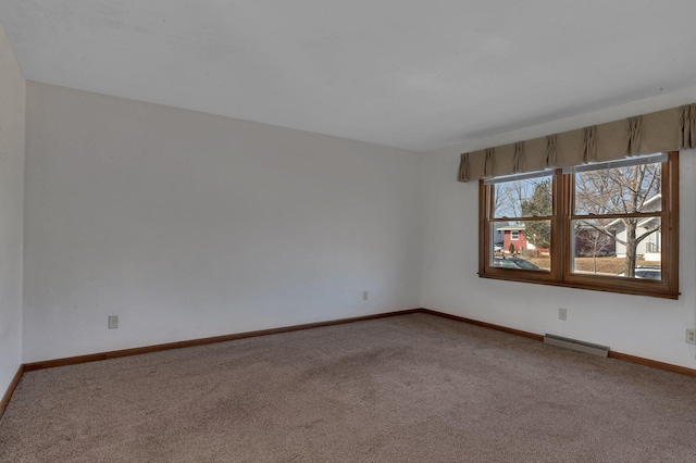 unfurnished room with visible vents, carpet floors, and baseboards