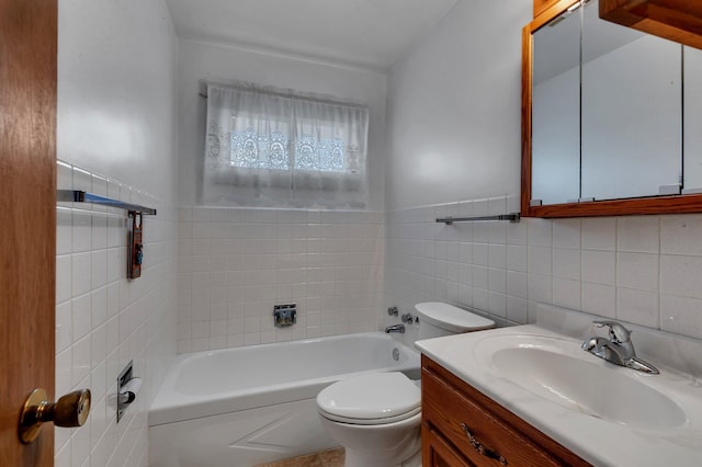 bathroom with a tub, toilet, tile walls, and vanity