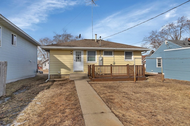 rear view of house with a shingled roof