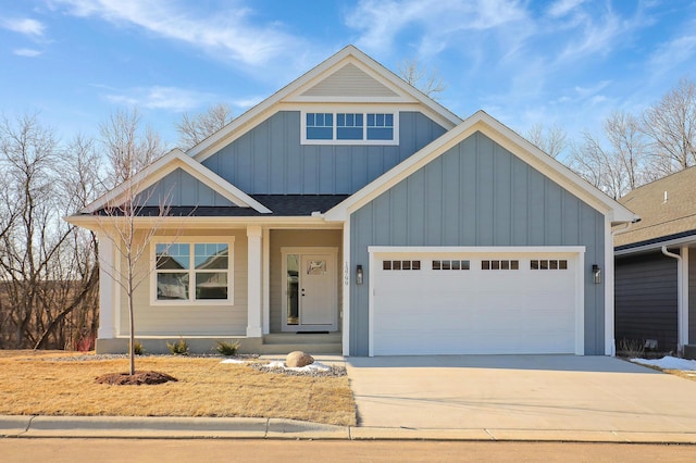 view of front facade featuring a garage, driveway, a shingled roof, and board and batten siding