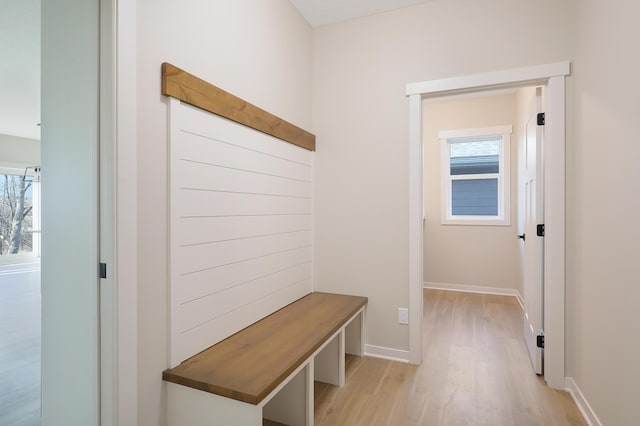 mudroom with light wood-style floors and baseboards