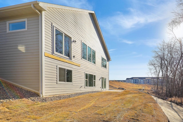 view of side of home with a lawn