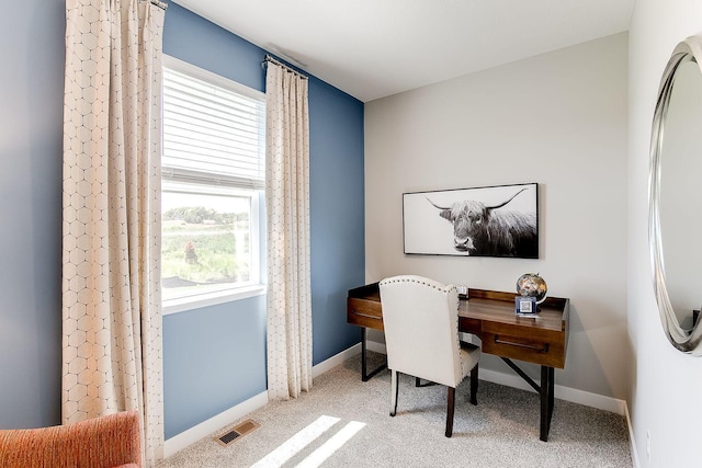 carpeted office featuring visible vents and baseboards