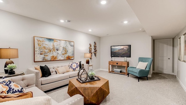 living room featuring recessed lighting, light colored carpet, and baseboards