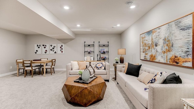 living room featuring light carpet, recessed lighting, and baseboards