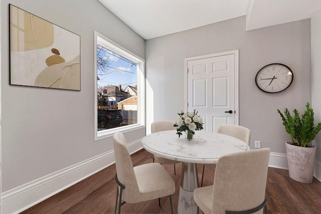 dining area featuring dark wood finished floors and baseboards