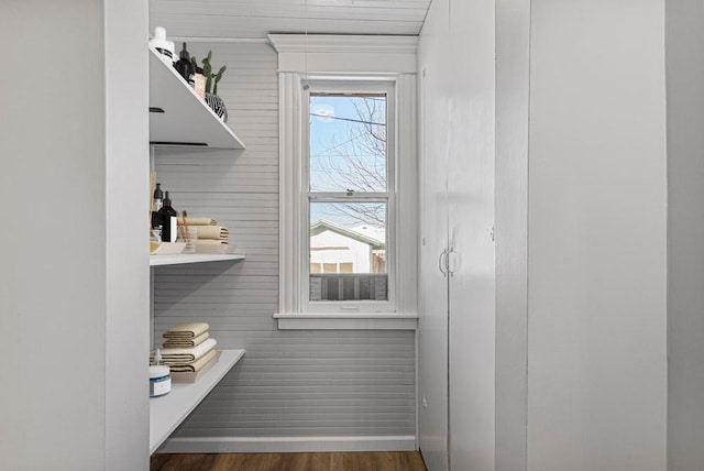 interior space featuring baseboards and wood finished floors