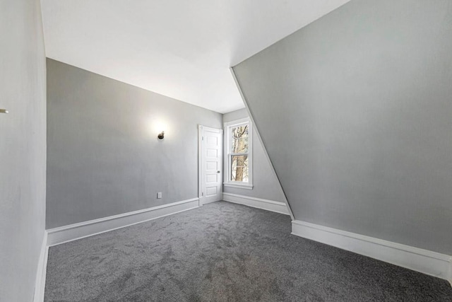 bonus room featuring carpet flooring and baseboards