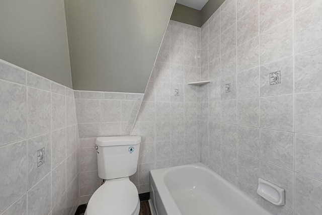 full bathroom featuring a bath, walk in shower, toilet, and tile walls