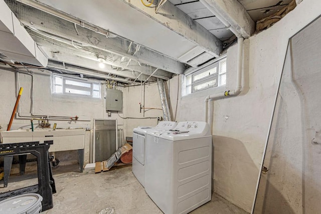 washroom featuring washer and dryer, laundry area, electric panel, and plenty of natural light